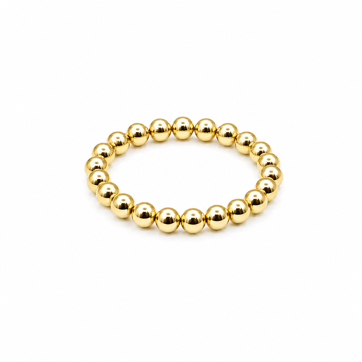 A gold beaded stretch bracelet made of polished metallic spherical beads, displayed on a clean white background.