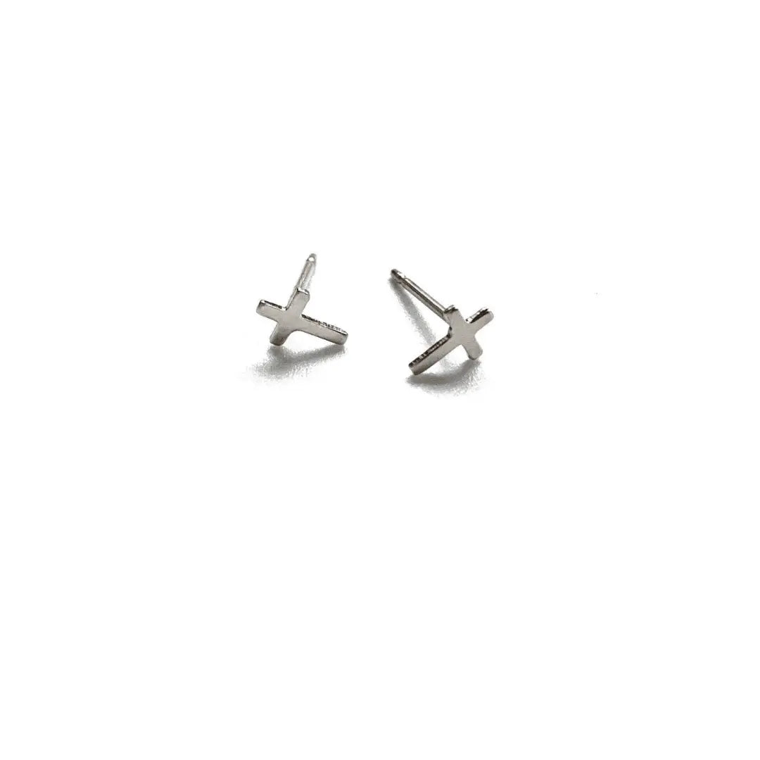 Sterling silver teen stud earring featuring a tiny cross design by Erin Gray, minimalist jewelry for young style.