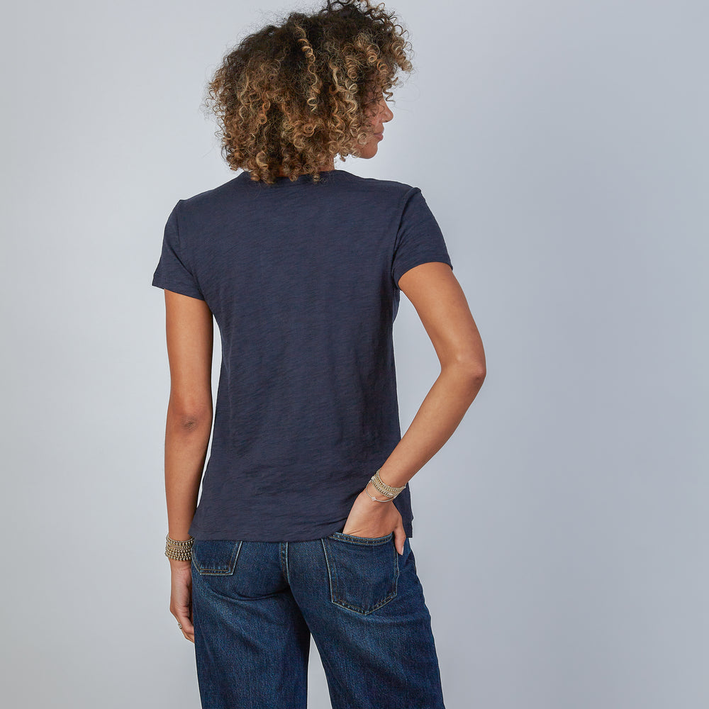 
                      
                        Woman wearing an erin gray design navy blue jeans crew tee and jeans against a gray background
                      
                    