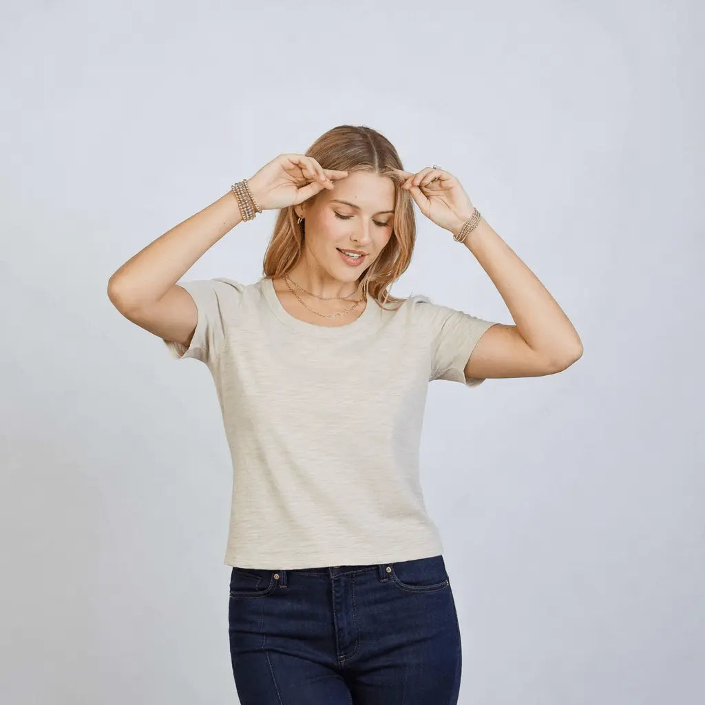 Light beige Erin Gray Saturday short sleeve tee shirt displayed flat, showcasing its casual crew neck and soft fabric.