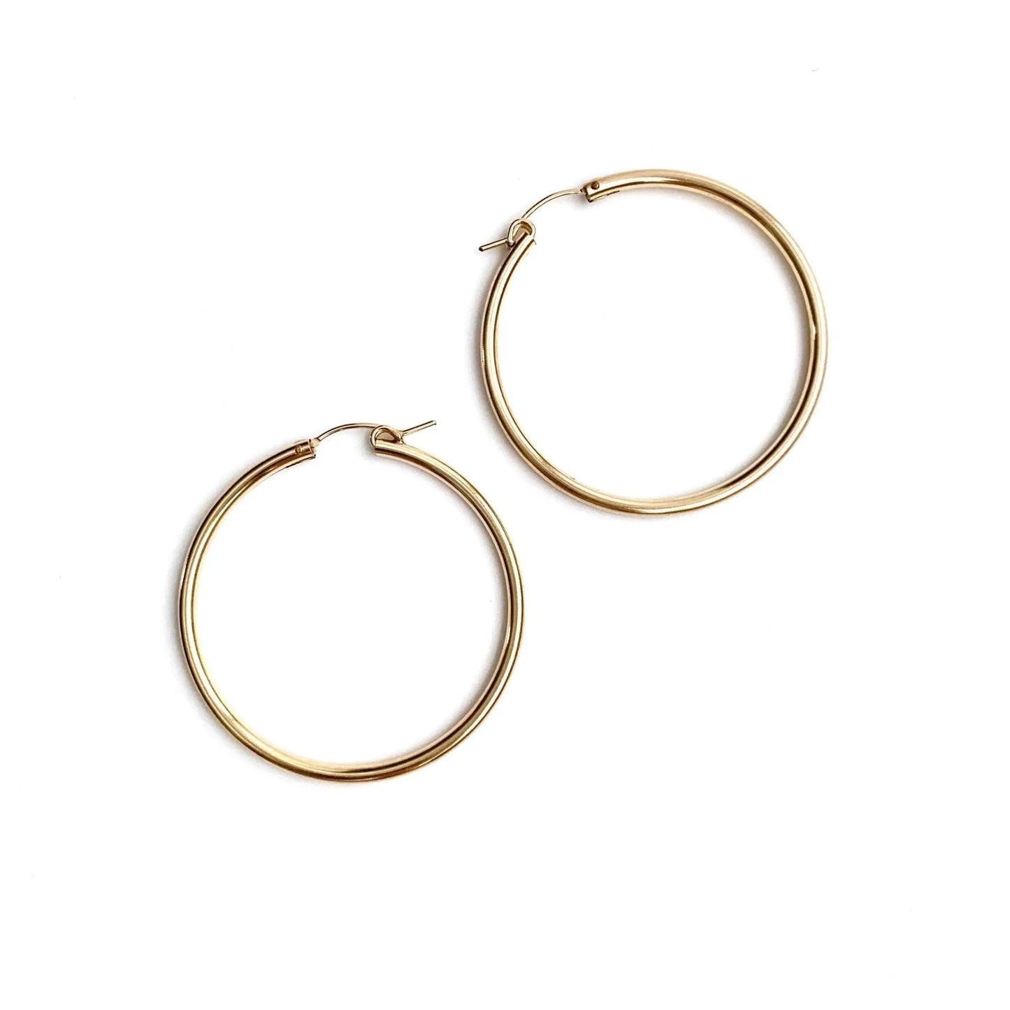 Carmel Gold Filled 27mm Hoop Earring by erin gray, showcasing a shiny gold-toned jewelry hoop on a plain background.