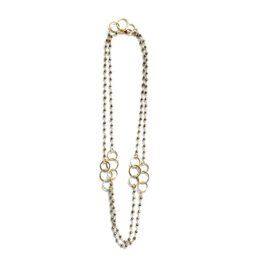 Gold-tone pyrite necklace with three hoop pendants by erin gray, featuring a stylish layered jewelry design.