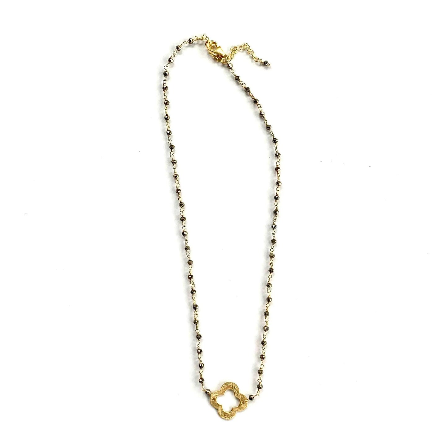 Erin Gray short necklace with a pyrite pendant and a small clover charm, featuring gold-tone jewelry design.