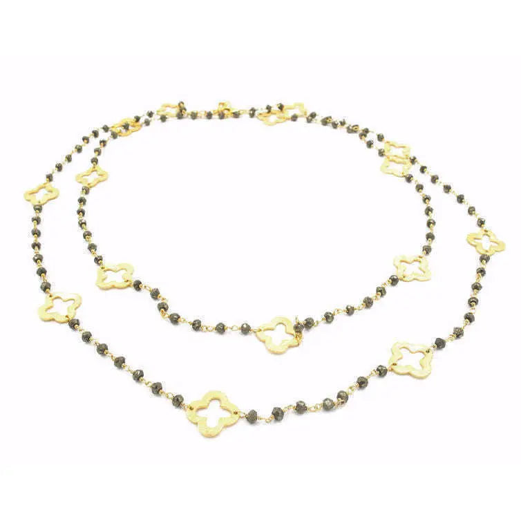 Gold clover and petite pyrite long necklace by erin gray featuring a delicate chain with clover and pyrite pendant accents.