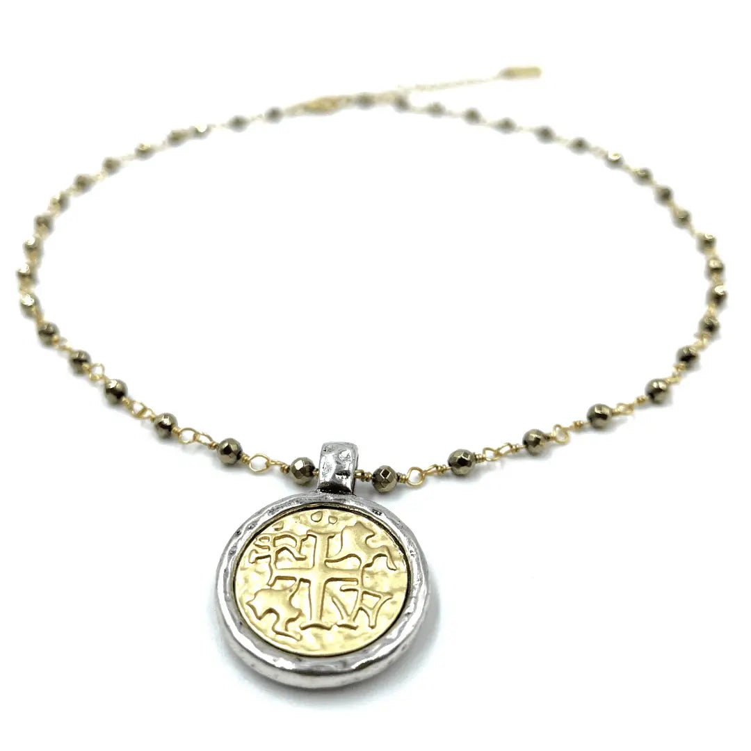 Matte gold coin pendant on pyrite short necklace by erin gray, featuring a circular gold coin charm on a delicate chain.